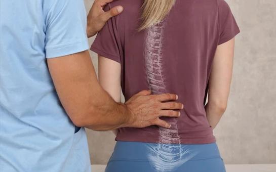 Chiropractic Beavercreek OH Adjustment HP A chiropractor examining a patient's spine while they sit upright